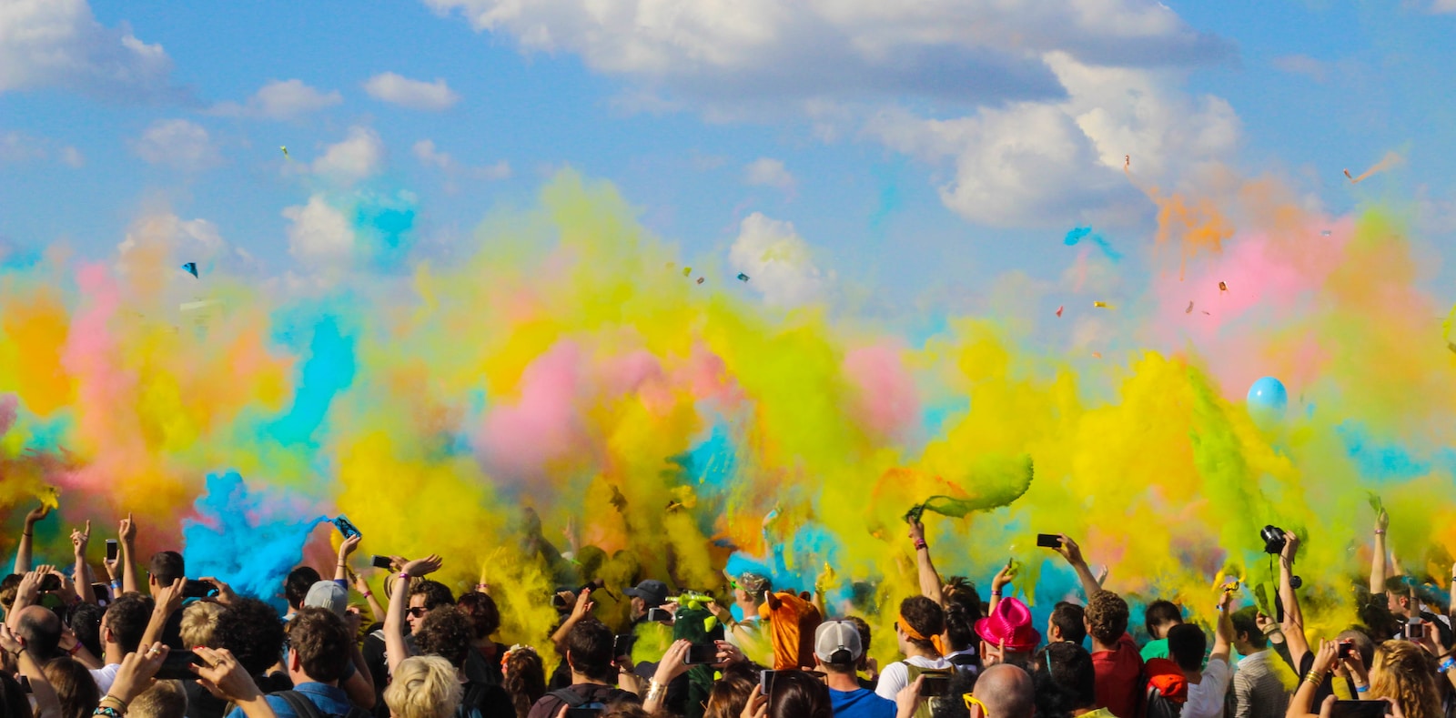 "what is culture?" expressed by a group of people celebrating with colorful powder during Holi Festival